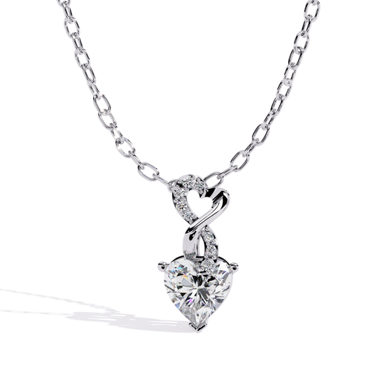 Twisted heart pendant in white gold featuring a heart-shaped diamond with delicate accent diamonds
