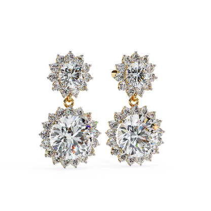 Alt Text: A pair of gold sunflower-shaped earrings featuring a sparkling round diamond at the center, surrounded by smaller diamonds in a flower-like design. A larger diamond drop pendant complements the design.