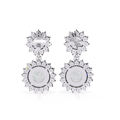  Elegant white-gold earrings with a delicate floral pattern and a sparkling centerpiece.