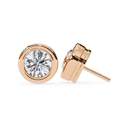 Rose gold stud earrings with a round diamond in a bezel setting