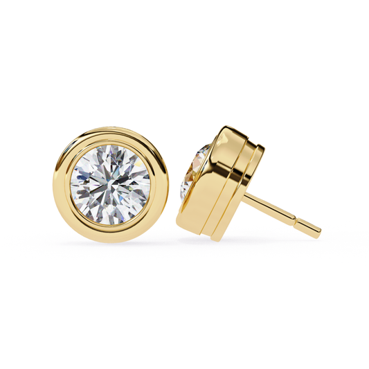 Yellow gold bezel set stud earrings featuring a round diamond