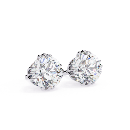 Elegant white gold solitaire earrings featuring sparkling round-cut diamonds in a secure six-prong setting, exuding sophistication and style.
