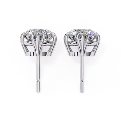Elegant white gold diamond earrings with a crown setting, highlighting the brilliance of the diamonds set in a secure, timeless design.