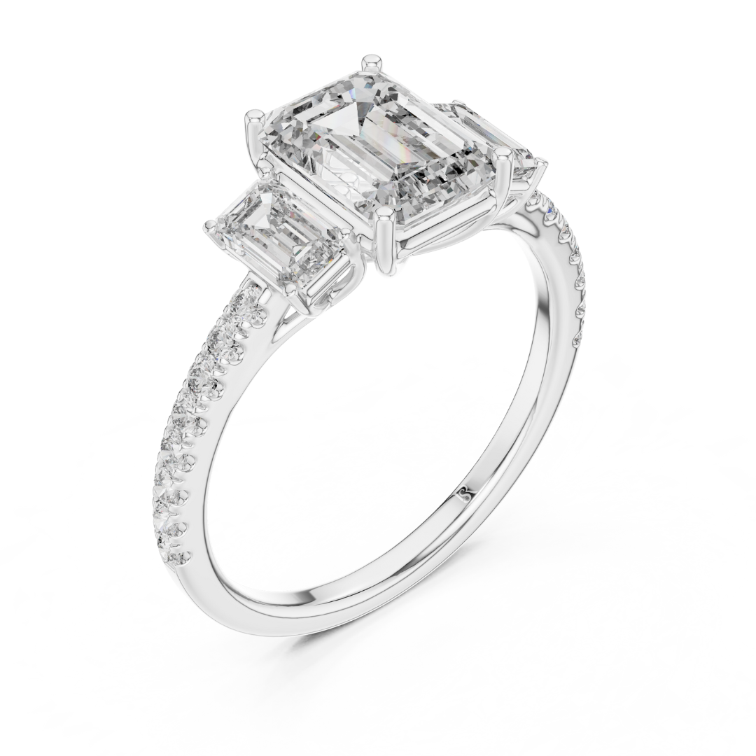 Angled view of emerald cut three stone diamond ring in white gold
White gold emerald diamond ring with pave band angled view
Emerald cut diamond engagement ring with side stones
Three stone emerald diamond ring in white gold perspective view
White gold ring with emerald cut center diamond angled view
Emerald cut lab diamond ring with pave band in white gold
Minimal white gold emerald diamond engagement ring angled view
Pave band three stone diamond ring perspective angle
Classic emerald cut engagement ring 
