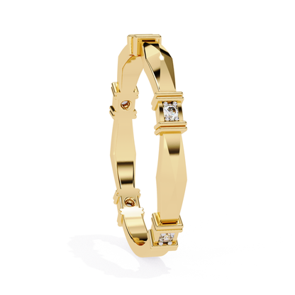 Close-up view of a yellow gold ring with clean geometric lines and diamond accents.