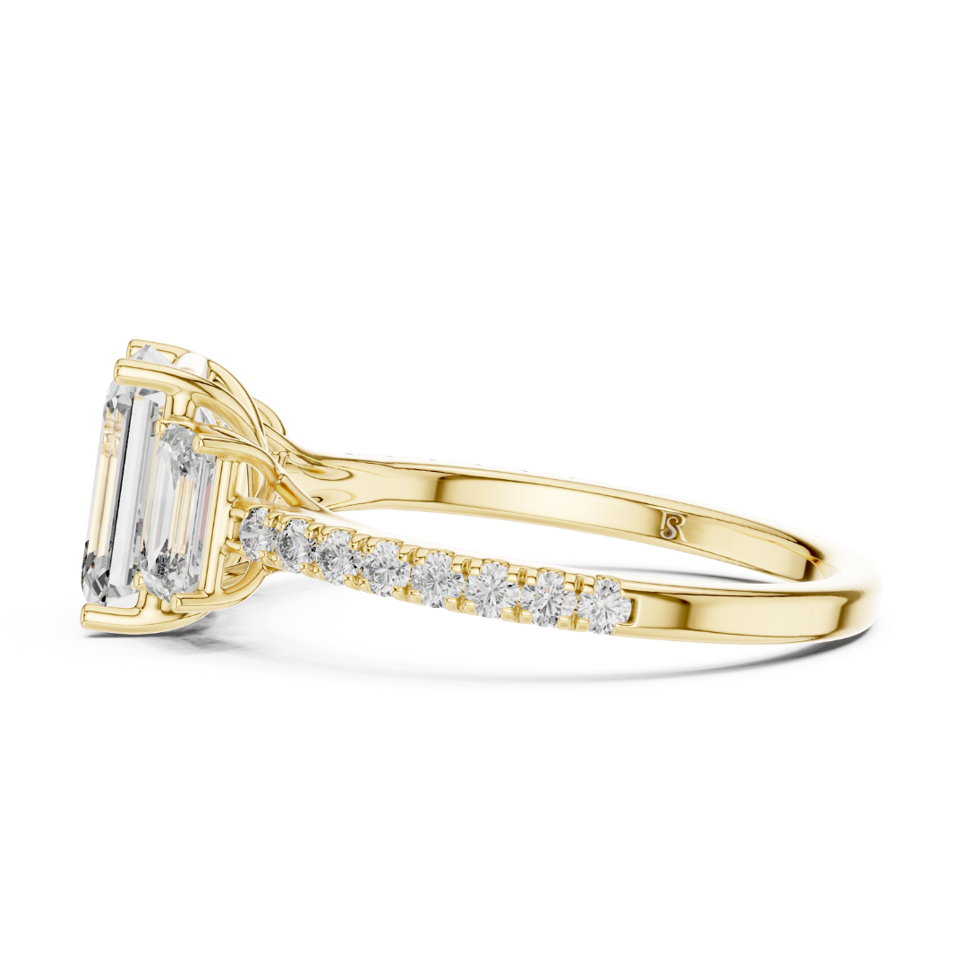 Profile view of emerald cut three stone diamond ring in yellow gold
Yellow gold emerald diamond ring with pave band profile view
Emerald cut diamond engagement ring side profile in yellow gold
Three stone emerald diamond ring profile angle
Yellow gold ring with emerald cut side stones profile view
Emerald cut lab diamond ring with pave band side angle
Minimal yellow gold emerald diamond ring profile view
Pave band three stone diamond ring in yellow gold
Classic emerald cut engagement ring profile view
Yello