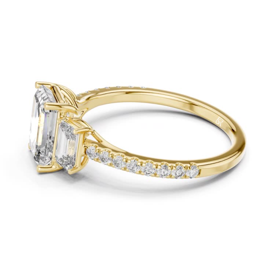 Side view of emerald cut three stone diamond ring in yellow gold
Yellow gold emerald diamond ring with pave band side view
Emerald cut diamond engagement ring side profile
Three stone emerald diamond ring in yellow gold side angle
Yellow gold ring with emerald cut diamonds side view
Emerald cut lab diamond ring with pave band profile
Minimal yellow gold emerald diamond ring side view
Side profile of three stone diamond ring with pave band
Classic emerald cut engagement ring in yellow gold side view
Yellow g