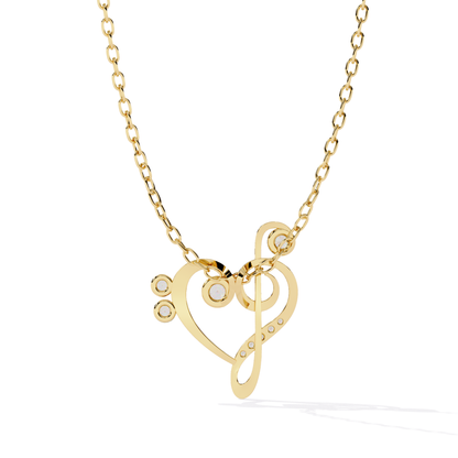 Gold necklace with a heart and music note pendant 