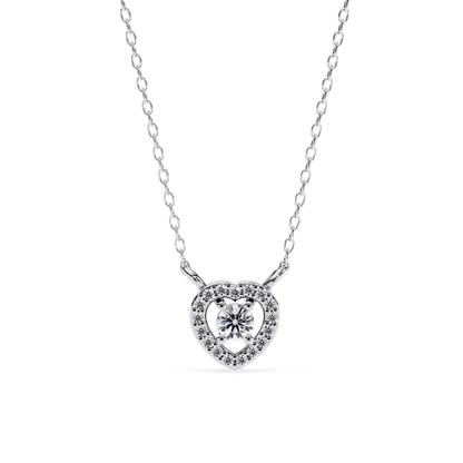 A white gold or silver necklace featuring a heart-shaped pendant with a central round-cut diamond surrounded by smaller pave-set diamonds, suspended on a delicate chain.