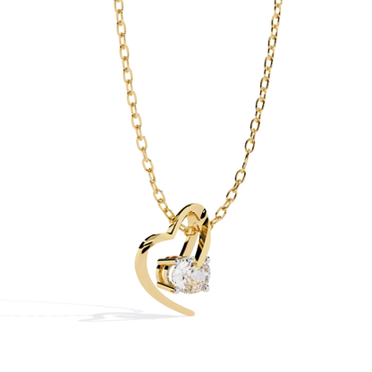Side view of a heart shaped curved pendant with a single round stone set inside the open design in yellow tone