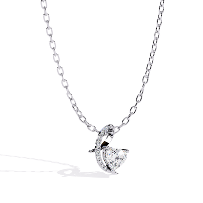 White gold heart pendant featuring a brilliant cut diamond and curved pavé detail