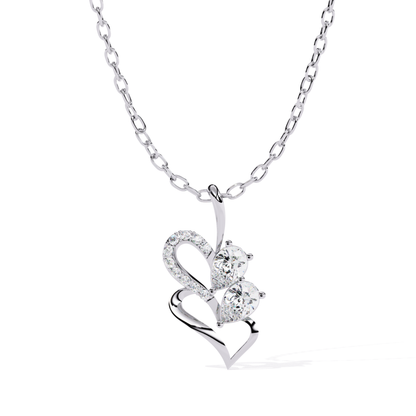 Open heart pendant designed with a smooth outline, containing two pear-cut stones and a line of closely set accent stones