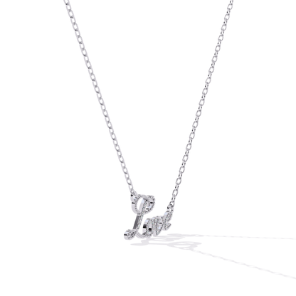 Angled view of white gold love pendant highlighting the thickness and curved design