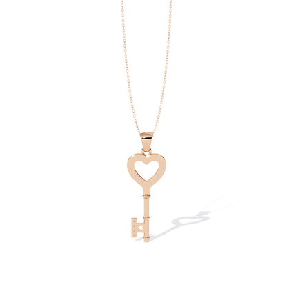 Rose gold open heart key pendant rear view featuring open heart back cutout, dotted diamond seat holes, smooth metal back, and straight key rear design