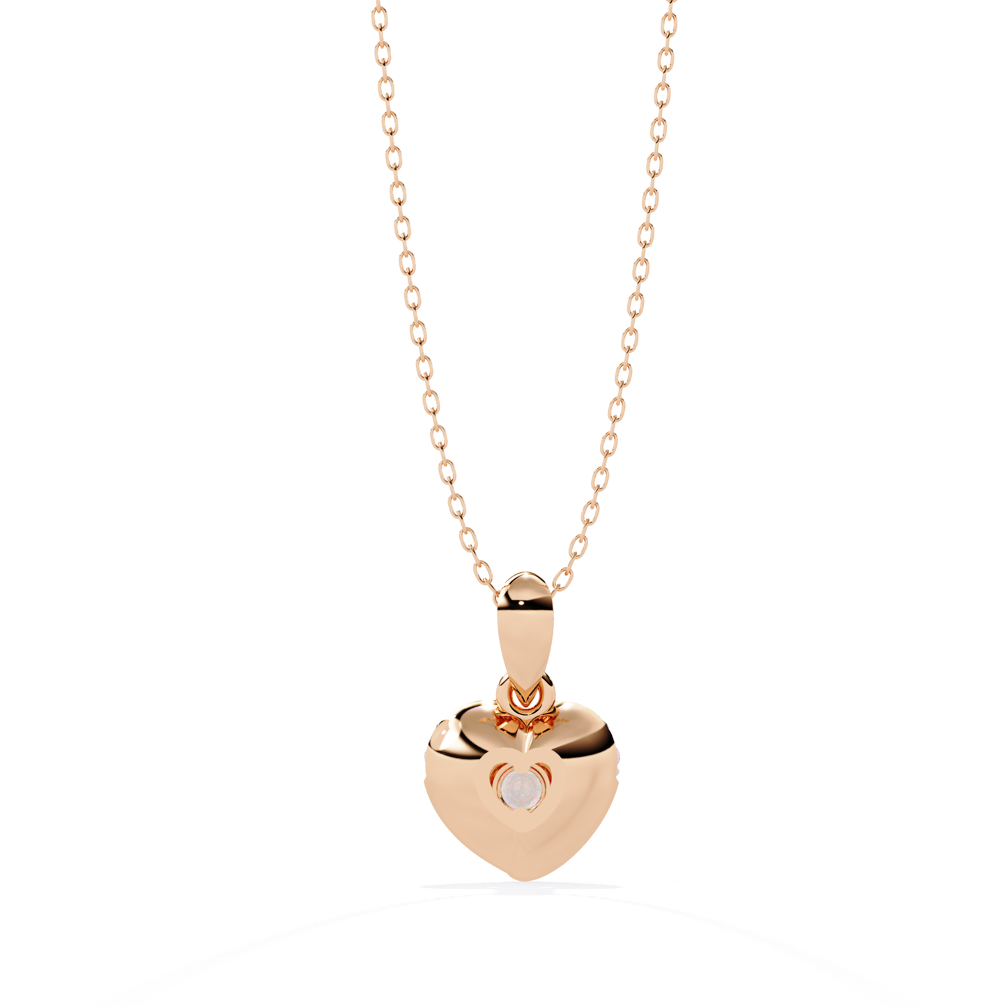 rose gold reverse view of round brilliant diamond heart drop pendant in rose gold, featuring a softly contoured open heart design with partial bezel support, prong set center stone, small round diamonds along the upper arc, and a smooth rose gold bail with refined metal finish.