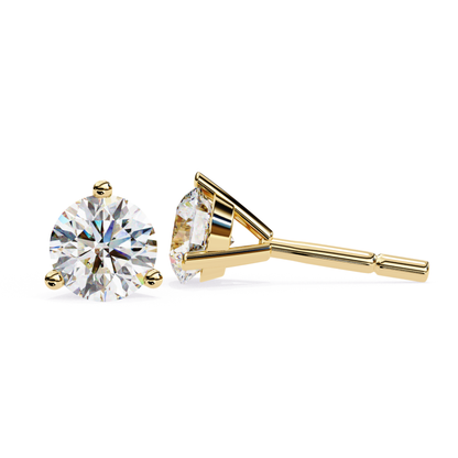 A pair of round brilliant cut diamond studs set in 14k yellow gold 3-prong martini settings, shown from the front and side.