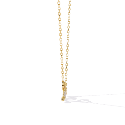 Gold necklace with a small pendant on a white background