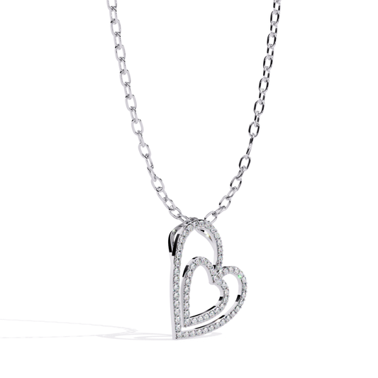 White gold double open heart diamond pendant in angled view featuring overlapping open hearts, polished inner heart, and diamond-lined outer heart frame