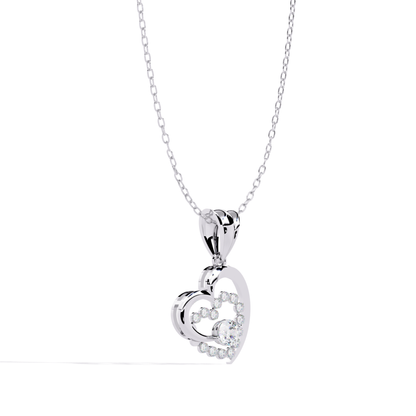 profile view of a white gold heart shaped pendant showcasing a layered design with round diamonds set around a central stone