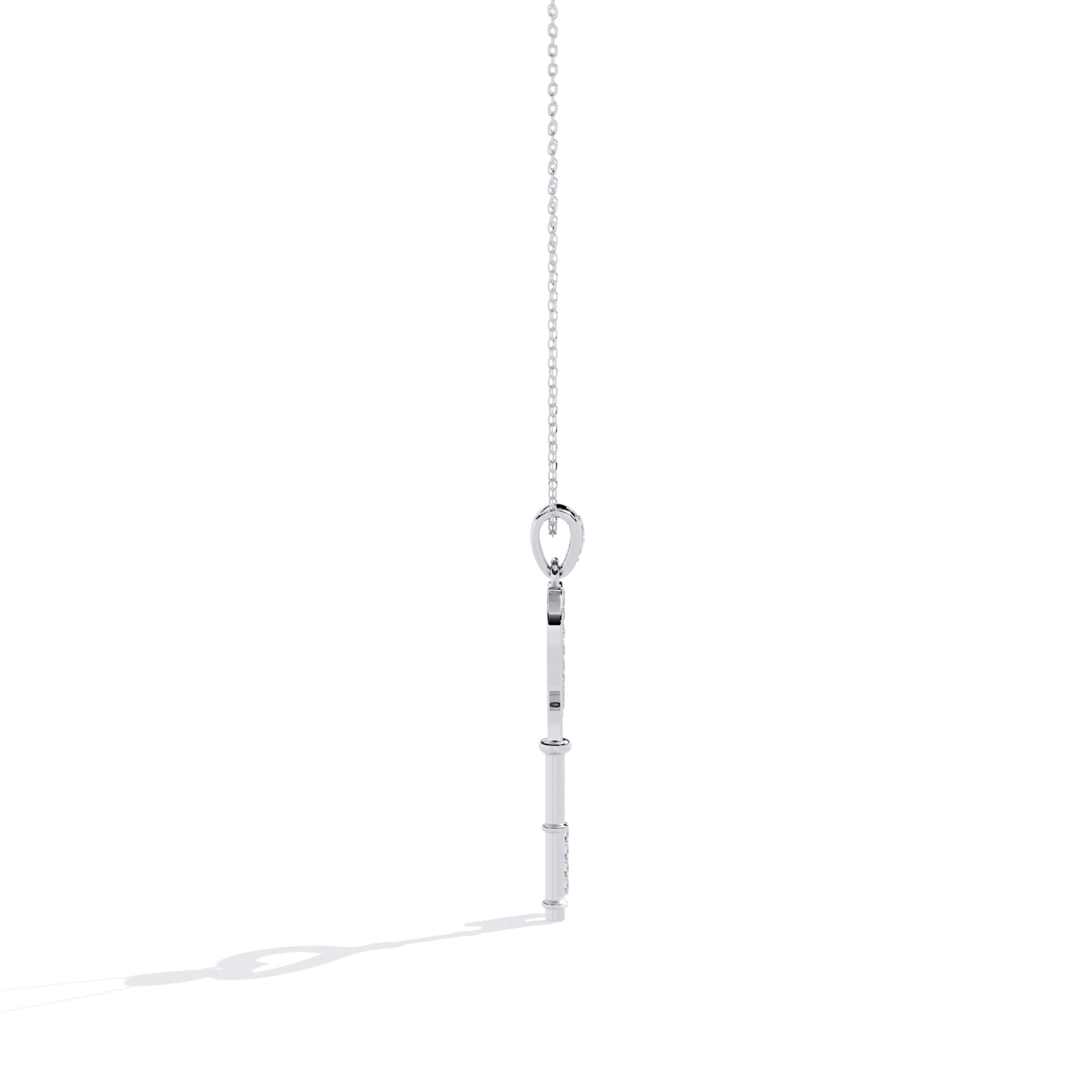 White gold open heart key pendant side view highlighting slim key body thickness, polished side surface, and diamond-accented key end