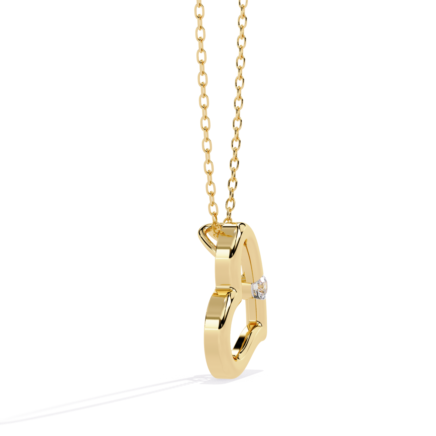 Side view of an open heart pendant in yellow gold with a single round diamond accent