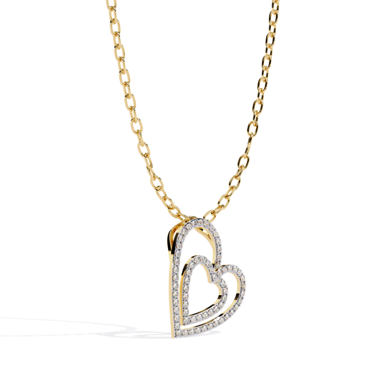 Yellow gold double open heart diamond pendant shown in angled side view highlighting layered heart design, curved depth, and diamond-set outer heart edges